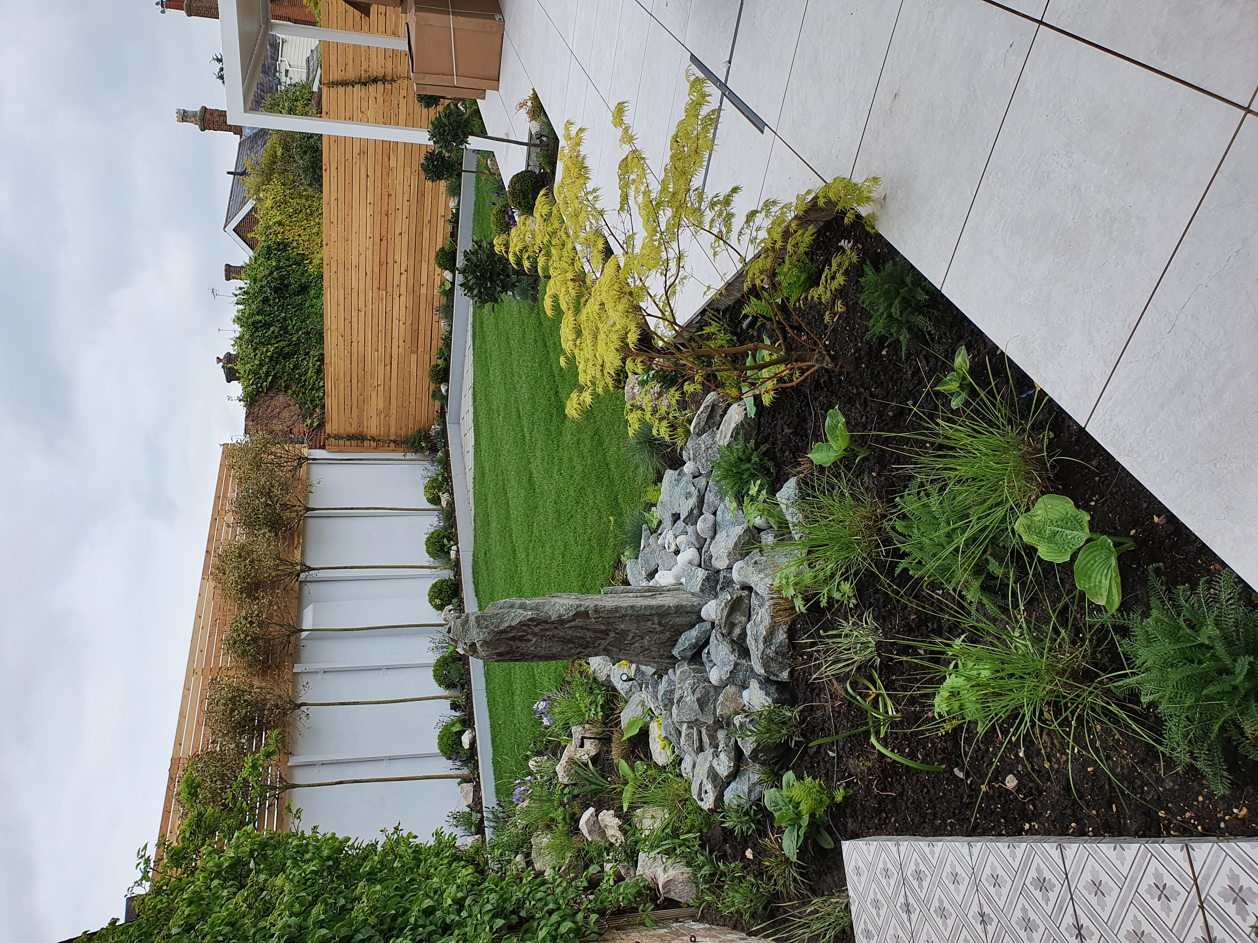 Natural stone retreat garden with lush greenery